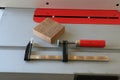 F clamp with red handle on table saw