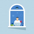 A man in a windows house looks out of a room or apartment  work on a laptop  Concept people sit at home  working Royalty Free Stock Photo