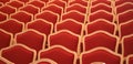 f empty elegant red velvet chairs of an indoor theater without p