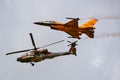 f-16 fighter aircraft and ah-64 apache attack heli Royalty Free Stock Photo