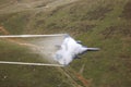 F15 fighter jet performs low flying through the mountains Royalty Free Stock Photo