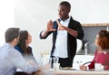 F.O.C.U.S.a handsome young businessman addressing his team during a meeting. Royalty Free Stock Photo