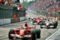 Group of Formula One cars, arriving to the finish line with cheering fans in blurred background AI generated Royalty Free Stock Photo
