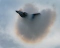 F22 Raptor creating a pressure wave in the form of white fog on the sky background