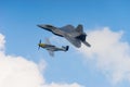 F-22 Raptor and p51 Mustang in the clouds Royalty Free Stock Photo
