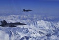 FA-18 military jets from Swiss Airforce escorting civil airplaine in the swiss alps