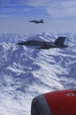 FA-18 military jets from Swiss Airforce escorting civil airplaine in the swiss alps