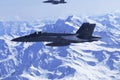 FA-18 military jets from Swiss Airforce escorting civil airplaine in the swiss alps