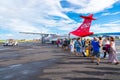 Happy tourists boarding Air Tahiti ATR 72 from Papeete, French Polynesia, Oceania.