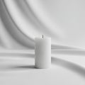 Fabric backdrop. The candle is unlit, with a black wick at the top. Royalty Free Stock Photo