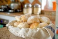 fabric basket with assorted bread rolls on a kitchen counter Royalty Free Stock Photo