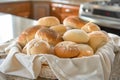 fabric basket with assorted bread rolls on a kitchen counter Royalty Free Stock Photo