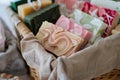 fabric basket with a selection of handmade soaps and lotions