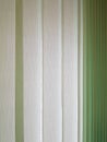 Fabric blinds in the form of green vertical stripes. Royalty Free Stock Photo