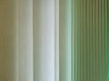 Fabric blinds in the form of green vertical stripes. Royalty Free Stock Photo