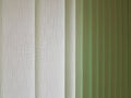 Fabric blinds in the form of green vertical stripes. Royalty Free Stock Photo