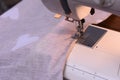 the fabric is clamped by the foot sewing machine while sewing. Royalty Free Stock Photo