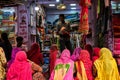 Fabric clothes vendor showing new samples to local women in Sadar Market. Jodhpur, Rajasthan, India Royalty Free Stock Photo