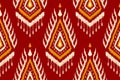 Fabric ethnic ikat art. Seamless pattern in tribal. Aztec geometric ornament print. Red background