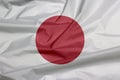 Fabric flag of Japan. Crease of Japanese flag background. Royalty Free Stock Photo