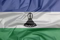 Fabric flag of Lesotho. Crease of Bosotho flag background.