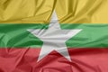 Fabric flag of Myanmar. Crease of Myanmarese flag background.