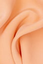 Fabric golden in natural silk. Peach smooth silk fabric