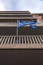 Greek flag waving on a balcony in Athens, Greece Royalty Free Stock Photo