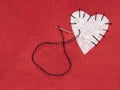 Fabric heart red with white patch and black sewing thread. Mend broken heart concept. Royalty Free Stock Photo