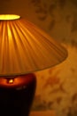 Fabric lampshade with golden warm light. Close-up, selective focus