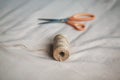 On the fabric lies a coil of coarse hemp rope and modern sharp scissors. Sewing and hobbies Royalty Free Stock Photo