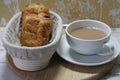 Fabric lined bread basket with French pastry`s and tea