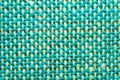 Fabric macro texture. knitted textile. woven background. woolen material. weaving green and yellow threads close up Royalty Free Stock Photo
