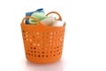 Fabric in orange plastic basket on white Royalty Free Stock Photo