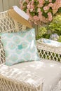 Fabric pillow, needle, thread and buttons sewing notions on chair in garden. Spring and summer home decorating crafts projects Royalty Free Stock Photo