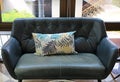 Fabric pillows on leather sofa Royalty Free Stock Photo