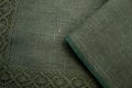 Fabric sample green natural flax with lace. Textile manufacture Royalty Free Stock Photo