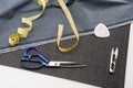 Fabric, scissors and measuring tape for dressmaking Royalty Free Stock Photo