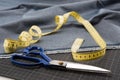 Fabric, scissors and measuring tape for dressmaking Royalty Free Stock Photo