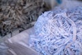 Fabric scraps, old clothing and textiles are cut into strips waiting for recycle.