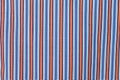 Fabric shirt with vertical stripes light blue, yellow,red and white texture background. Royalty Free Stock Photo