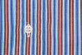 Fabric shirt with vertical stripes light blue, yellow,red and white texture background. Royalty Free Stock Photo