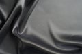 Fabric silk satin texture background black silber color. Royalty Free Stock Photo