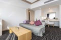 Fabric sofa and a working corner in the living room of a large apartment