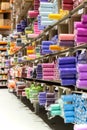 Fabric store with rolls of textile on shelves. Assortment of colorful clothes for sale in warehouse Royalty Free Stock Photo