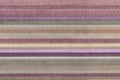 Fabric striped texture. Rustic canvas pattern. Colored striped coarse linen fabric closeup as background