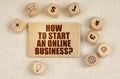 On the fabric there are cubes with drawings and a sign with the inscription - HOW TO START AN ONLINE BUSINESS Royalty Free Stock Photo