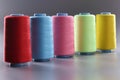 Fabric threads of different colors on gray background Royalty Free Stock Photo