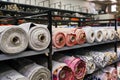 Fabric warehouse with many multicolored textile rolls