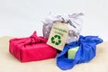 Fabric wrapping for gifts, sustainable living concept, zero waste, sustainable giving text and recycle icon